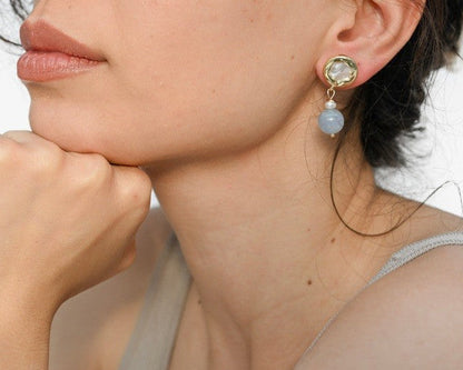 Woman wearing earrings with a neutral background